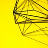 Creative geometric structure casting intricate shadows on a vibrant yellow background.